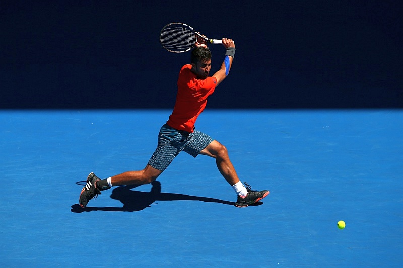 XXX of ZZZ plays a forehand in his/her first round match against XXXX of ZZZZ during day one of the 2016 Australian Open at Melbourne Park on January 18, 2016 in Melbourne, Australia.